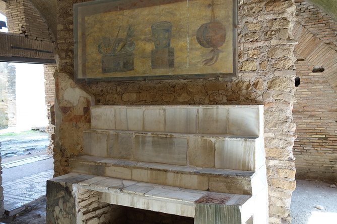 Ancient Ostia Antica Semi-Private Day Trip from Rome by Train with Guide - Forum, temples, shops, and what “port city” really means