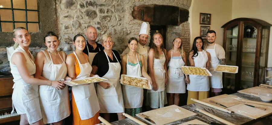 From Rome: Pasta Masterclass & Wine Tour in the Vineyard - Wearing an apron at the 9th generation wine farmhouse