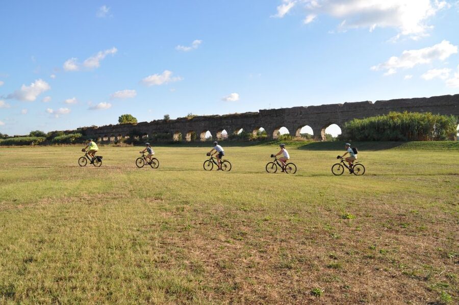 Rome: Appian Way, Catacombs & Roman Aqueducts Top EBike Tour - Parco degli Acquedotti and the aqueduct arches at golden-hour scale