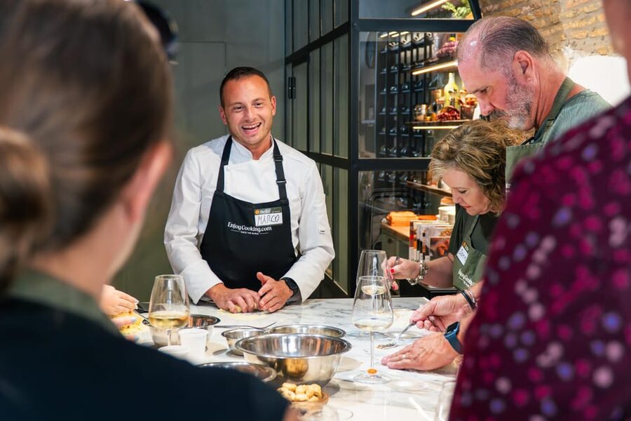 Rome: Pasta, Ravioli & Tiramisu Cooking Class by Colosseum - The kitchen vibe: small group, snacks, and wine that keeps it fun